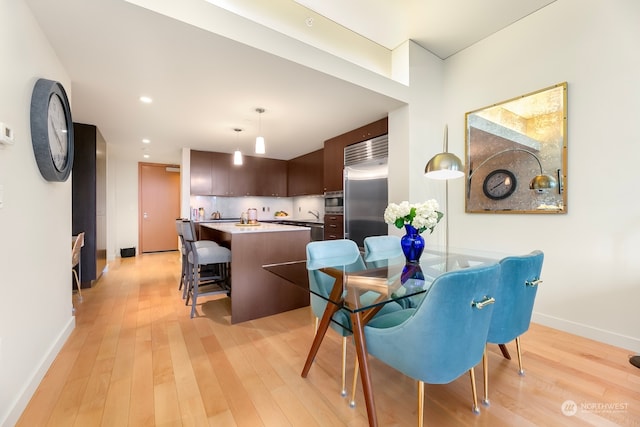 dining area featuring light wood-type flooring