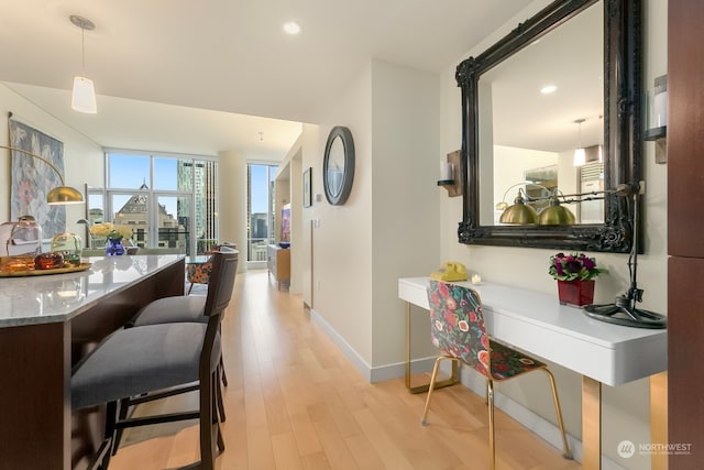 hallway with light hardwood / wood-style flooring