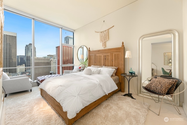 bedroom with light carpet and floor to ceiling windows