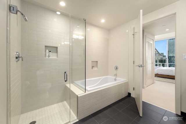 bathroom featuring tile patterned floors and independent shower and bath