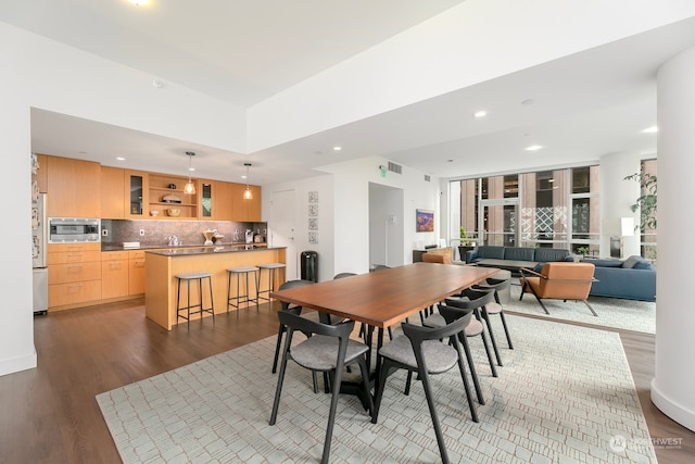 dining room with hardwood / wood-style flooring and sink