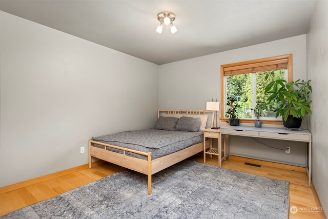 bedroom with hardwood / wood-style flooring