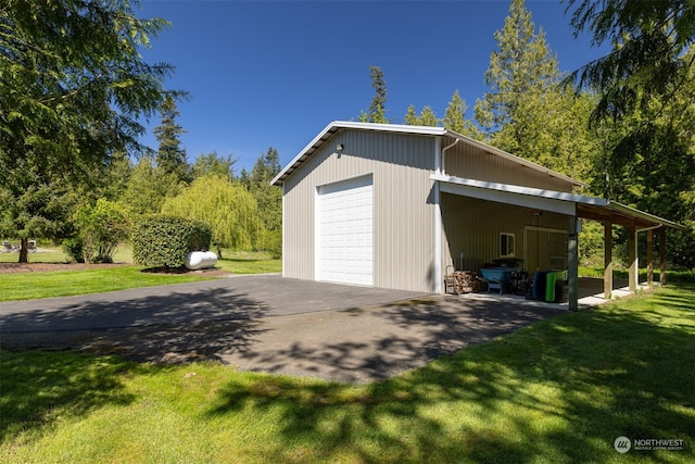 exterior space with a yard, a garage, and an outdoor structure