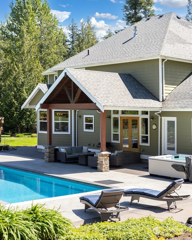 rear view of house with french doors, an outdoor hangout area, and a patio area