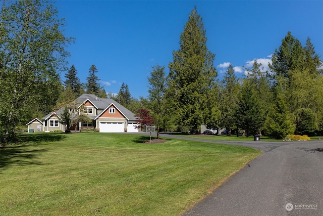 view of front of property with a garage and a front yard