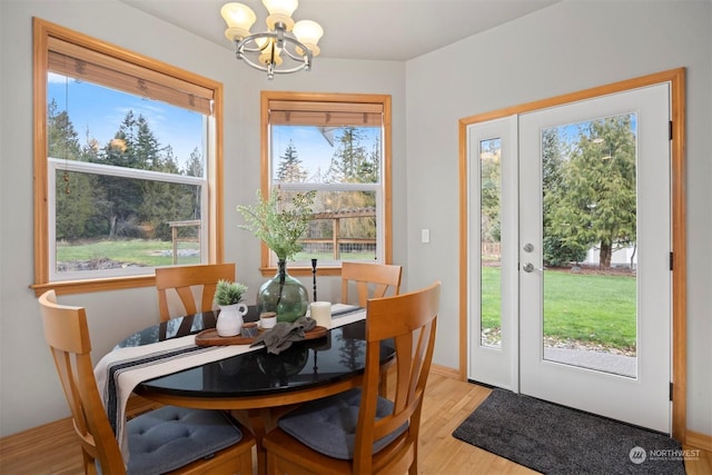 dining space featuring light hardwood / wood-style flooring and a notable chandelier