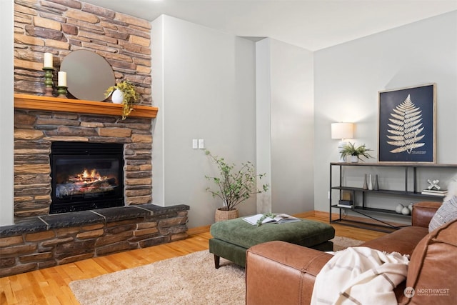 living room with hardwood / wood-style floors and a fireplace