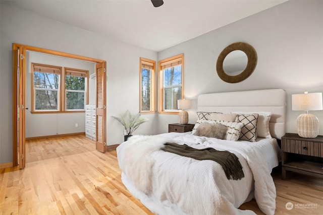 bedroom with ceiling fan and light hardwood / wood-style flooring