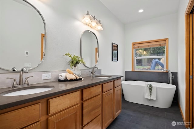 bathroom with vanity, a bath, and tile patterned flooring