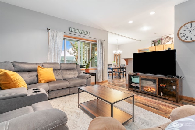 living room with light hardwood / wood-style flooring and a chandelier