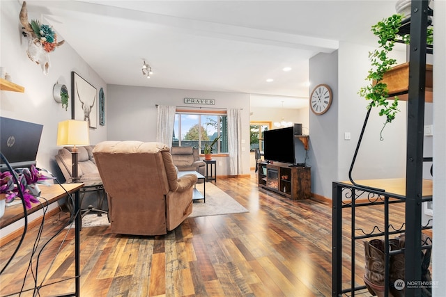 living room with a notable chandelier and hardwood / wood-style floors