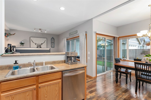 kitchen featuring dishwasher, hanging light fixtures, sink, a chandelier, and dark hardwood / wood-style flooring