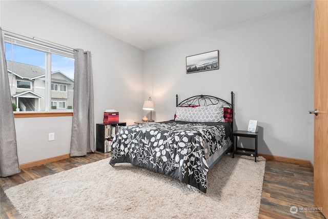 bedroom with dark hardwood / wood-style flooring