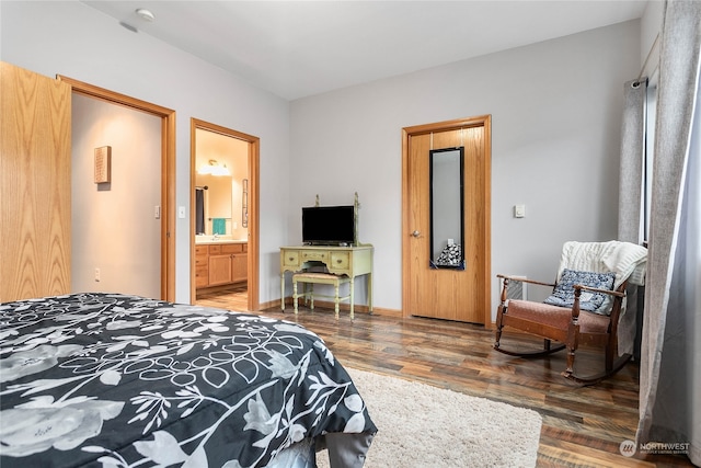 bedroom with dark wood-type flooring and ensuite bathroom