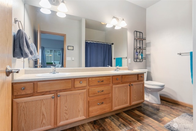 bathroom with vanity, hardwood / wood-style flooring, toilet, and a shower with curtain