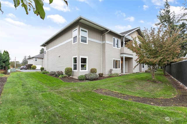 rear view of property featuring a yard and a balcony