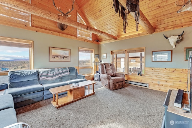 living room featuring a wealth of natural light, wooden walls, a baseboard heating unit, and carpet floors