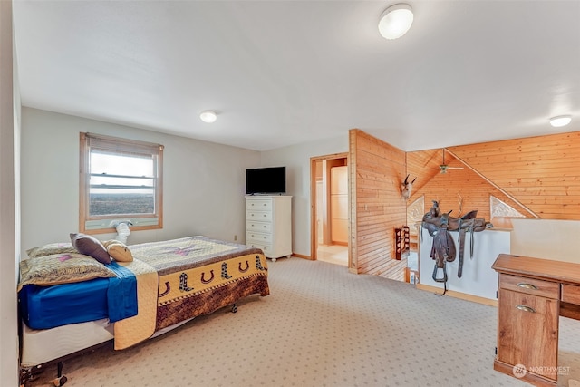 carpeted bedroom featuring wooden walls