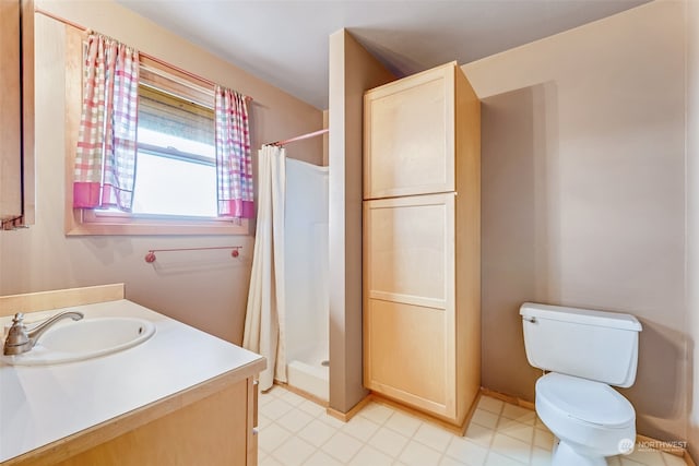 bathroom featuring toilet, vanity, and a shower with shower curtain