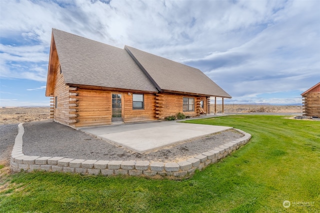 back of property with a patio area and a lawn