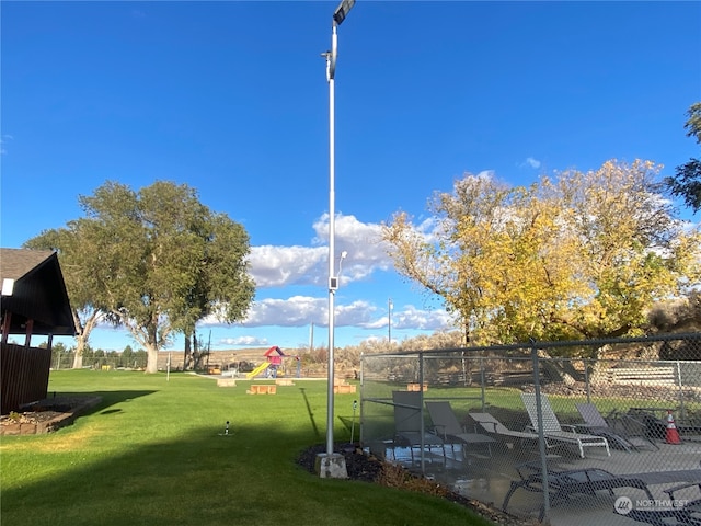 view of property's community featuring a yard and a patio