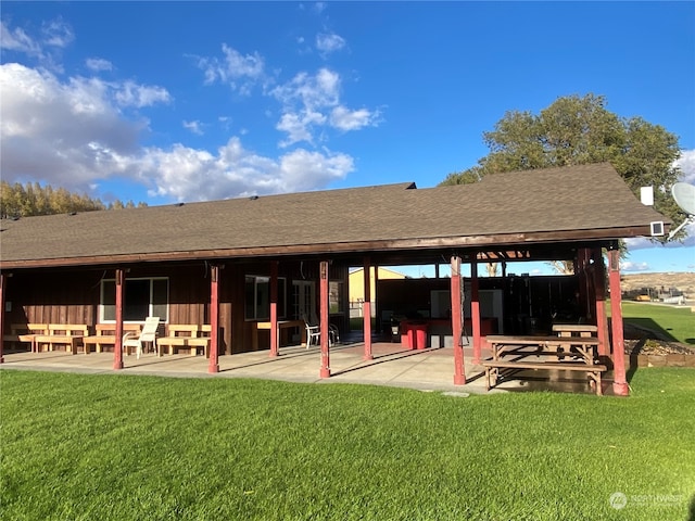 back of property featuring a patio area and a lawn