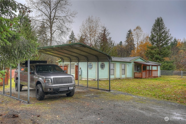 view of vehicle parking featuring a yard and a carport