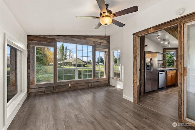 unfurnished sunroom featuring ceiling fan and vaulted ceiling