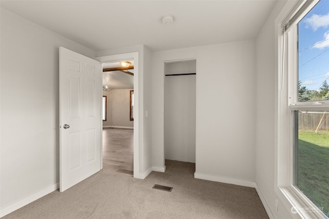 unfurnished bedroom with light colored carpet