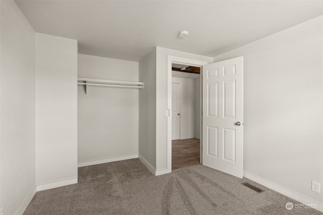 unfurnished bedroom featuring a closet and carpet