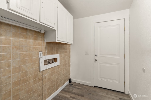 laundry room with tile walls, dark wood-type flooring, hookup for a washing machine, and cabinets