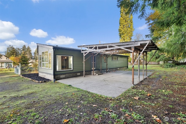 back of property featuring a carport, a patio, and a pergola