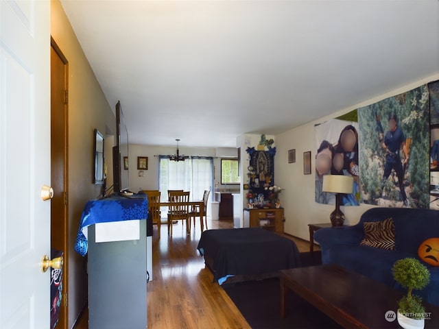 living room featuring hardwood / wood-style flooring and an inviting chandelier