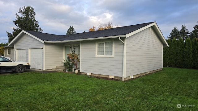 view of front of property with a garage and a front lawn