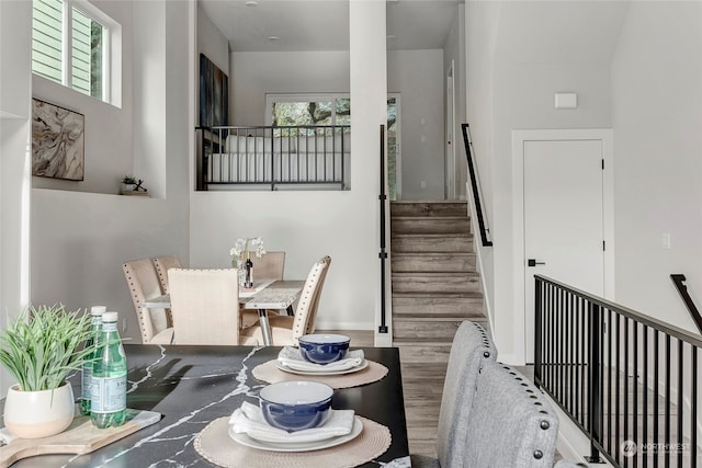 stairway featuring wood finished floors and baseboards