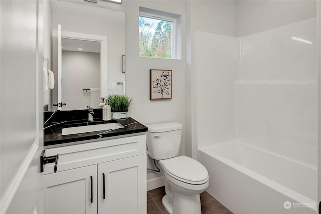 full bathroom with vanity, tub / shower combination, tile patterned floors, and toilet