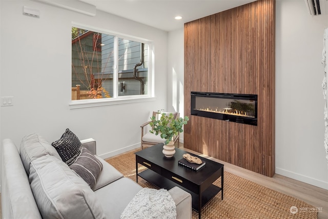 living room with light hardwood / wood-style floors and a fireplace