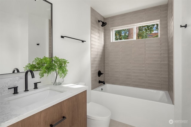 full bathroom with vanity, tiled shower / bath combo, and toilet