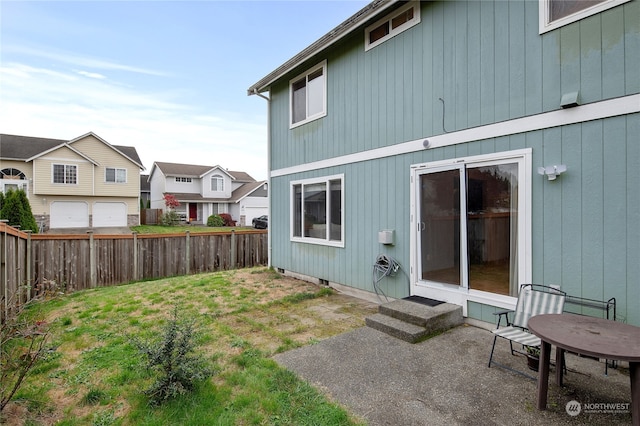 rear view of property with a yard and a patio