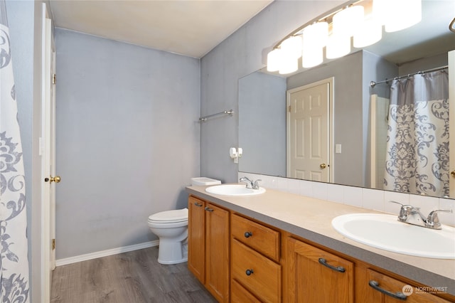 bathroom with vanity, hardwood / wood-style floors, and toilet