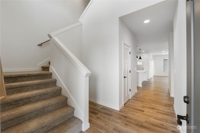 staircase with wood-type flooring