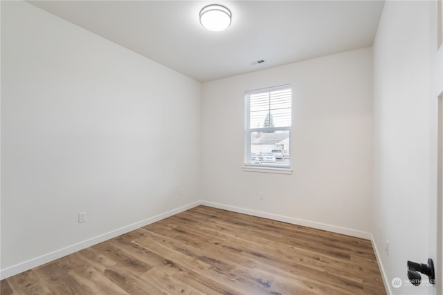 unfurnished room featuring hardwood / wood-style flooring