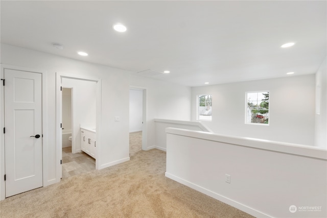 hallway featuring light carpet