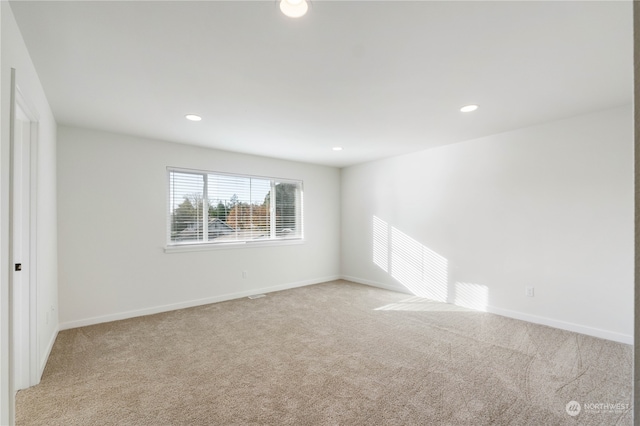 unfurnished room with light colored carpet