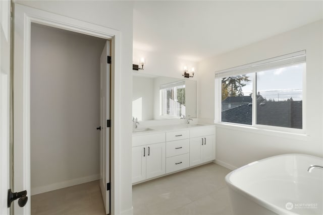 bathroom featuring vanity, tile patterned floors, and a bathtub