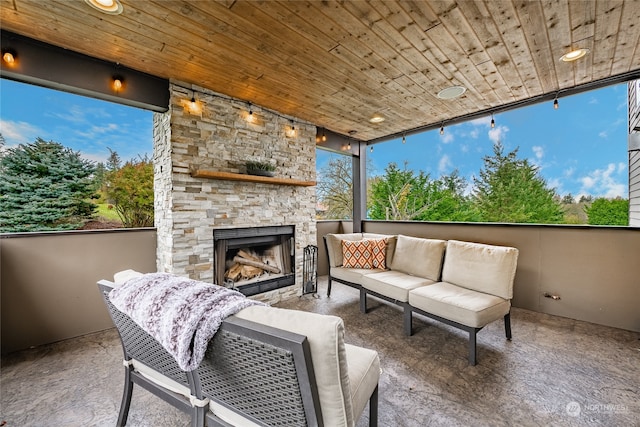 view of patio with an outdoor living space with a fireplace