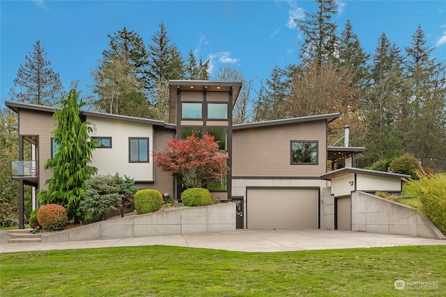 contemporary house featuring a front yard and a garage