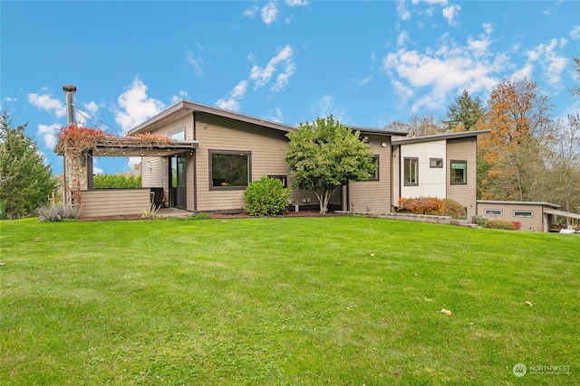 back of property featuring a patio area and a lawn