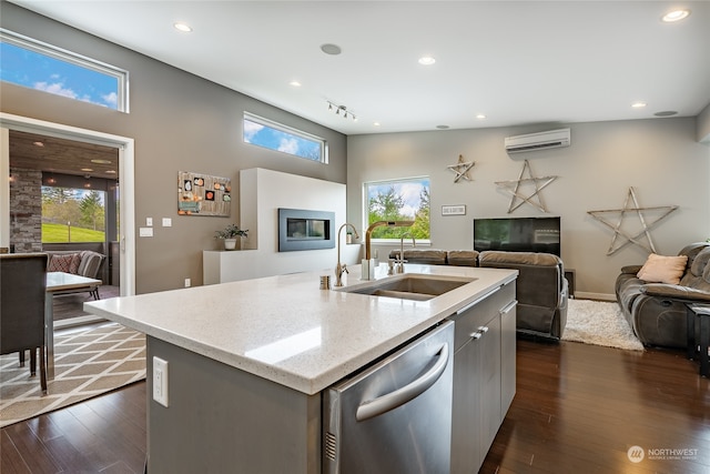 kitchen featuring sink, a wealth of natural light, dishwasher, and an island with sink