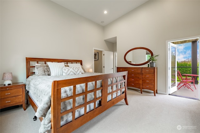 bedroom with light colored carpet, access to outside, and high vaulted ceiling